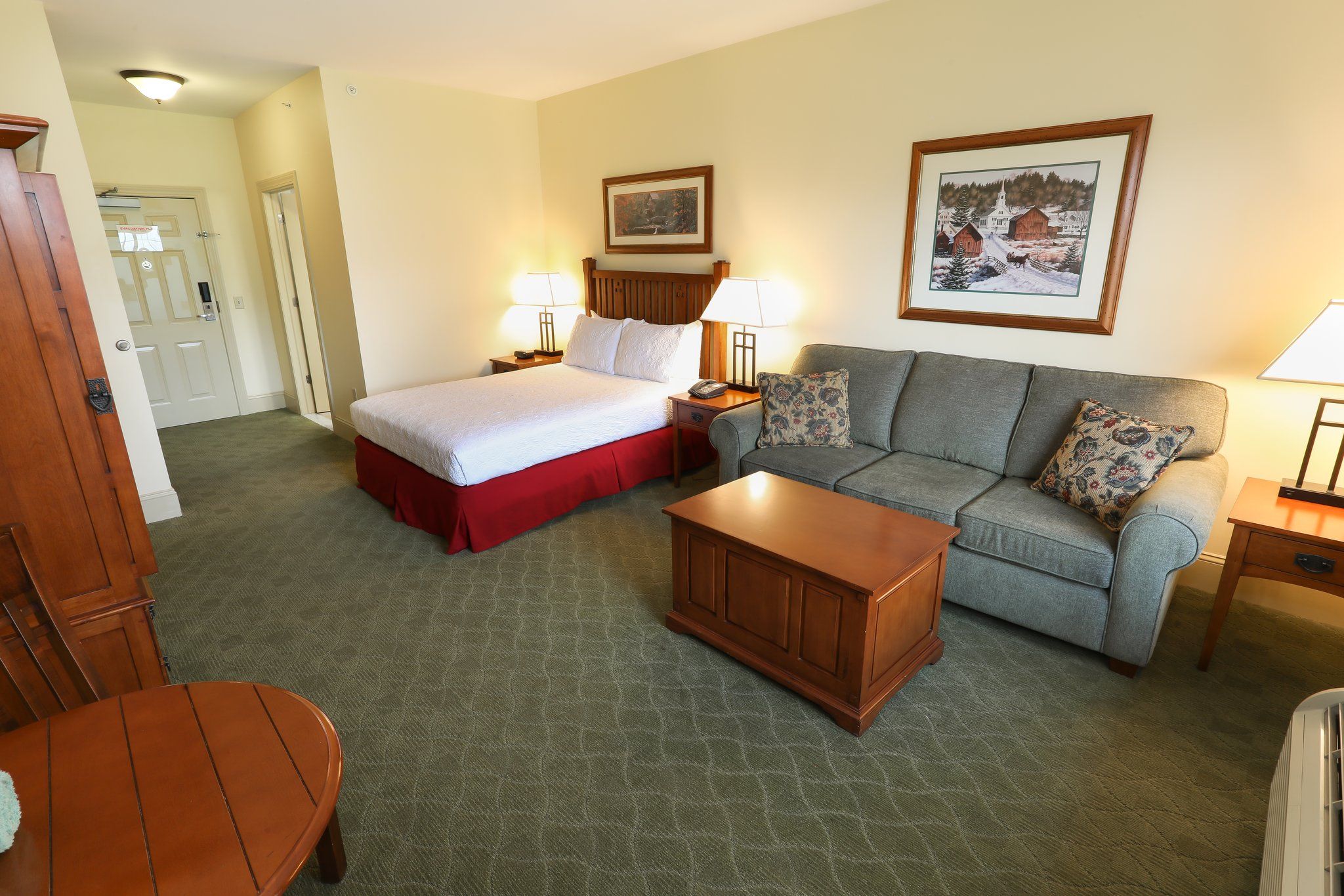image Plush bed and a living area with a sofa, offering plenty of space to relax.
