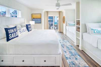 The third-floor bedroom includes a private balcony with gulf views plus two additional single beds.