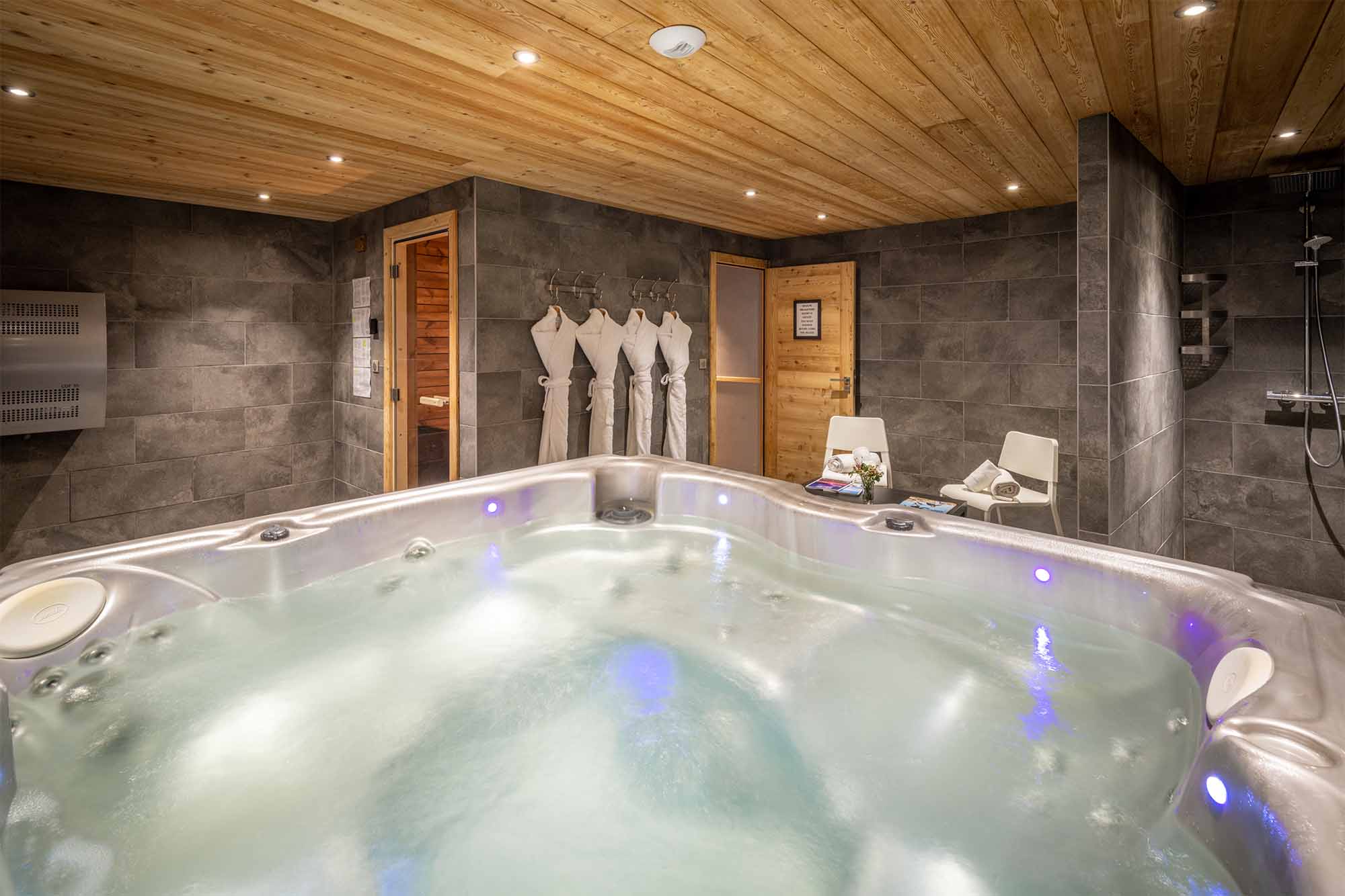 image Escape to our shared relaxation space, where an inviting indoor hot tub and sauna await to melt away the day's adventures.