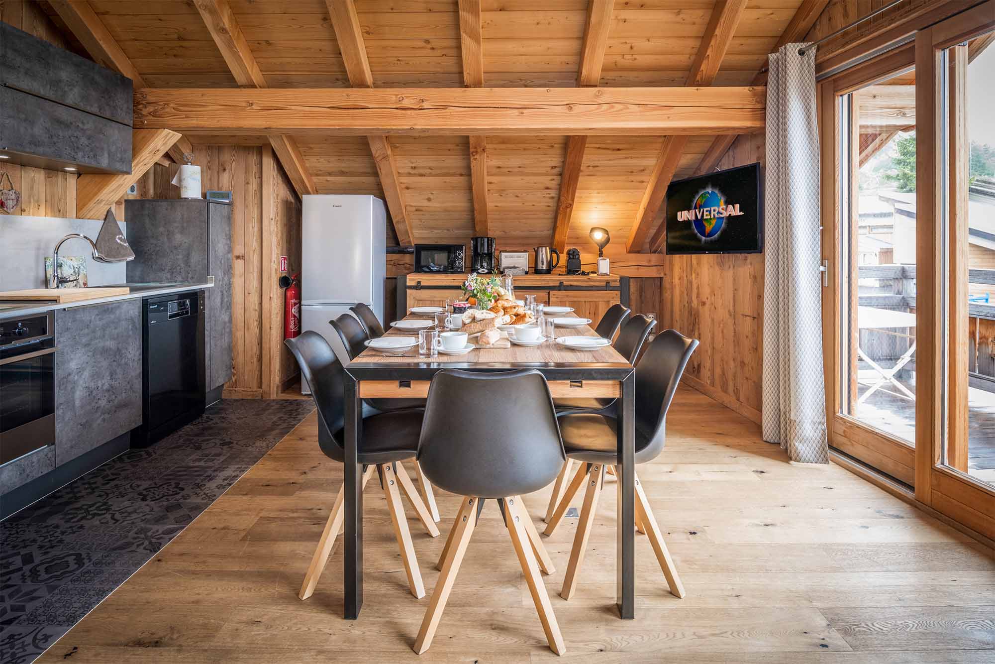 image The living area is light and airy, with vaulted ceilings in the eaves of the building..