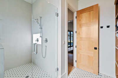 Refresh in the modern walk-in shower with toiletries.