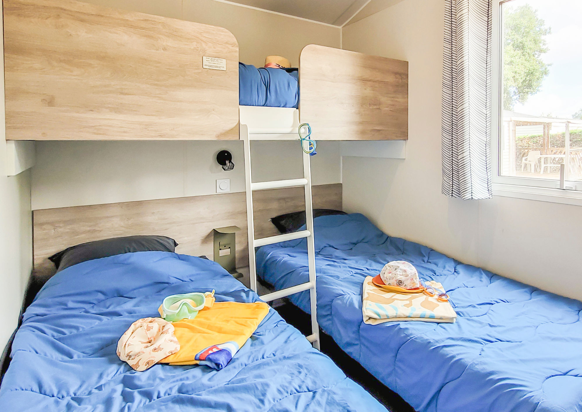 image The cozy twin bedroom showcases family-friendly design with vibrant bedding, ideal for relaxing seaside nights.