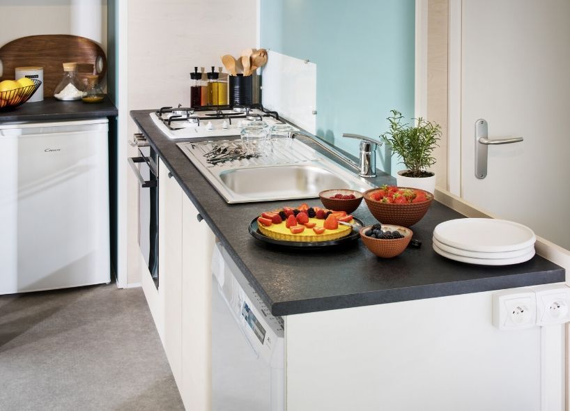 image This stylish kitchen area, equipped with contemporary appliances, invites families to prepare delicious meals in comfort and convenience.