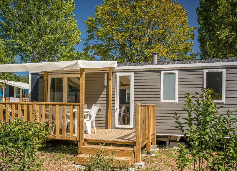image A charming mobile home with a sunny deck, perfect for relaxing outdoors in comfort.