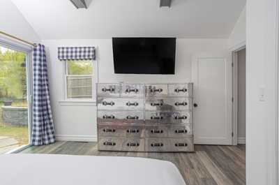 A large dresser and smart TV for you in the master bedroom.