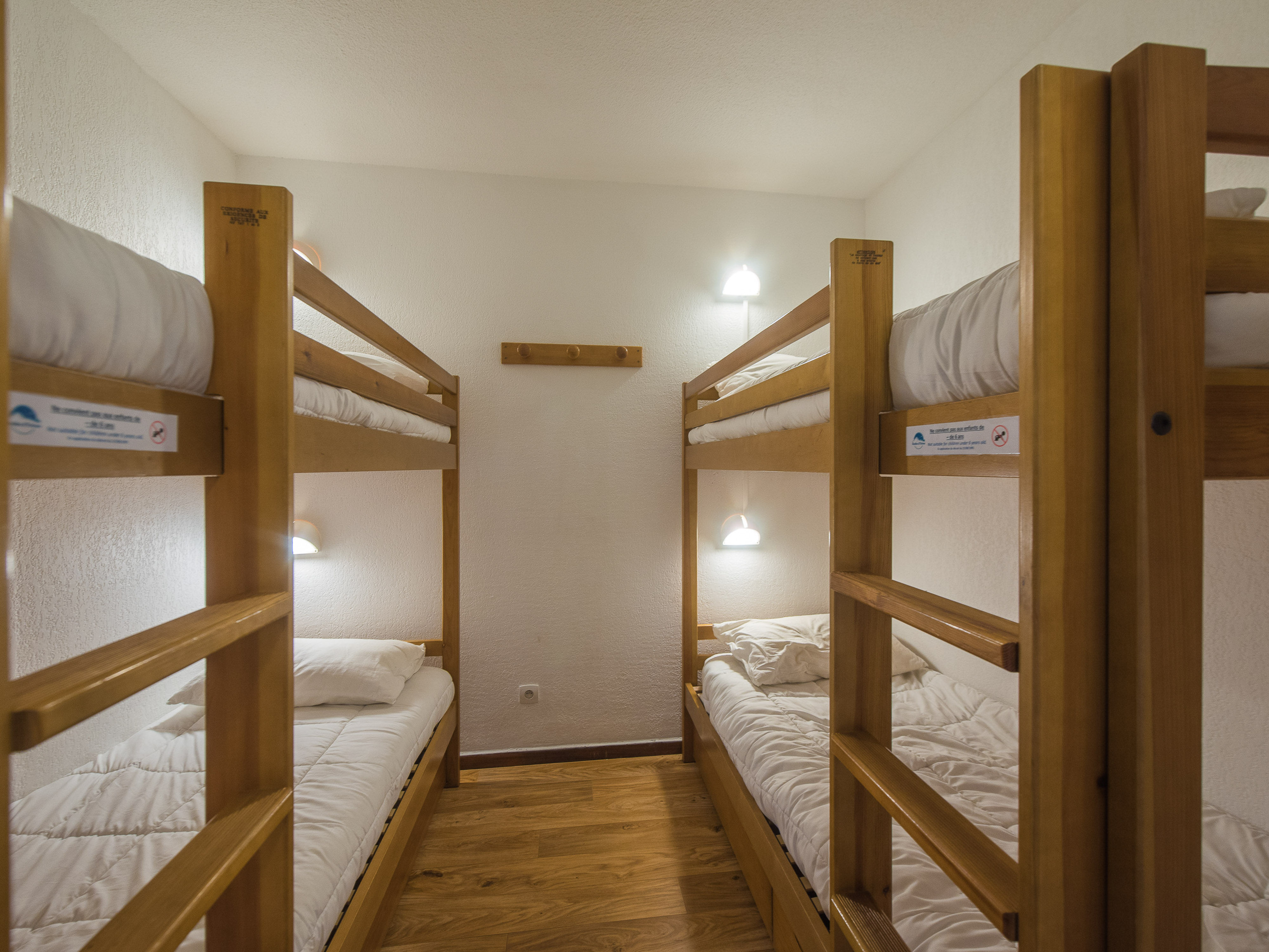 image Discover a compact and cozy space in our sleeping alcove, complete with two comfortable bunk beds perfect for a restful sleep.