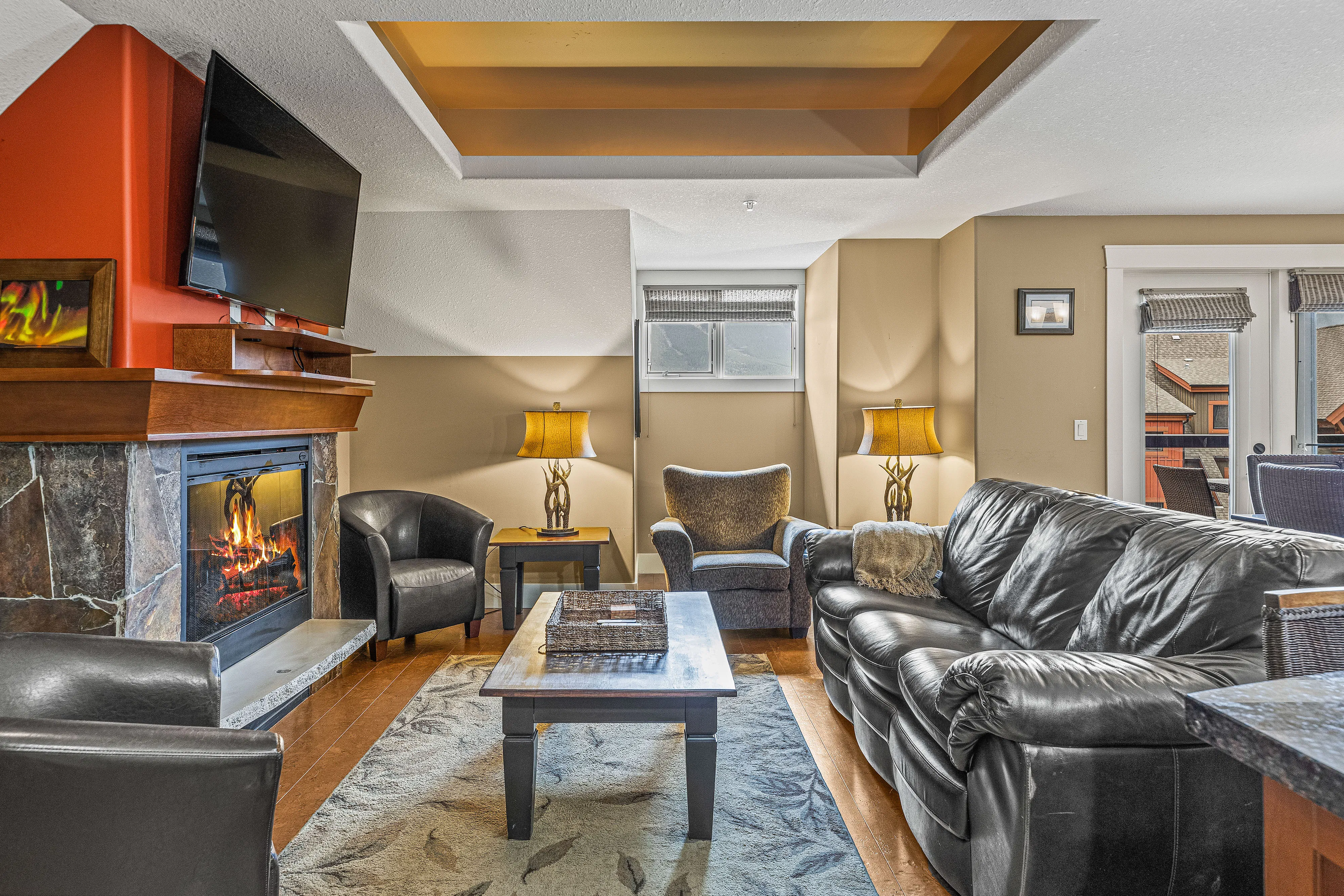 image Lounge in style with plush sofas, streaming TV, and a welcoming fireplace.