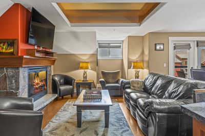 Lounge in style with plush sofas, streaming TV, and a welcoming fireplace.