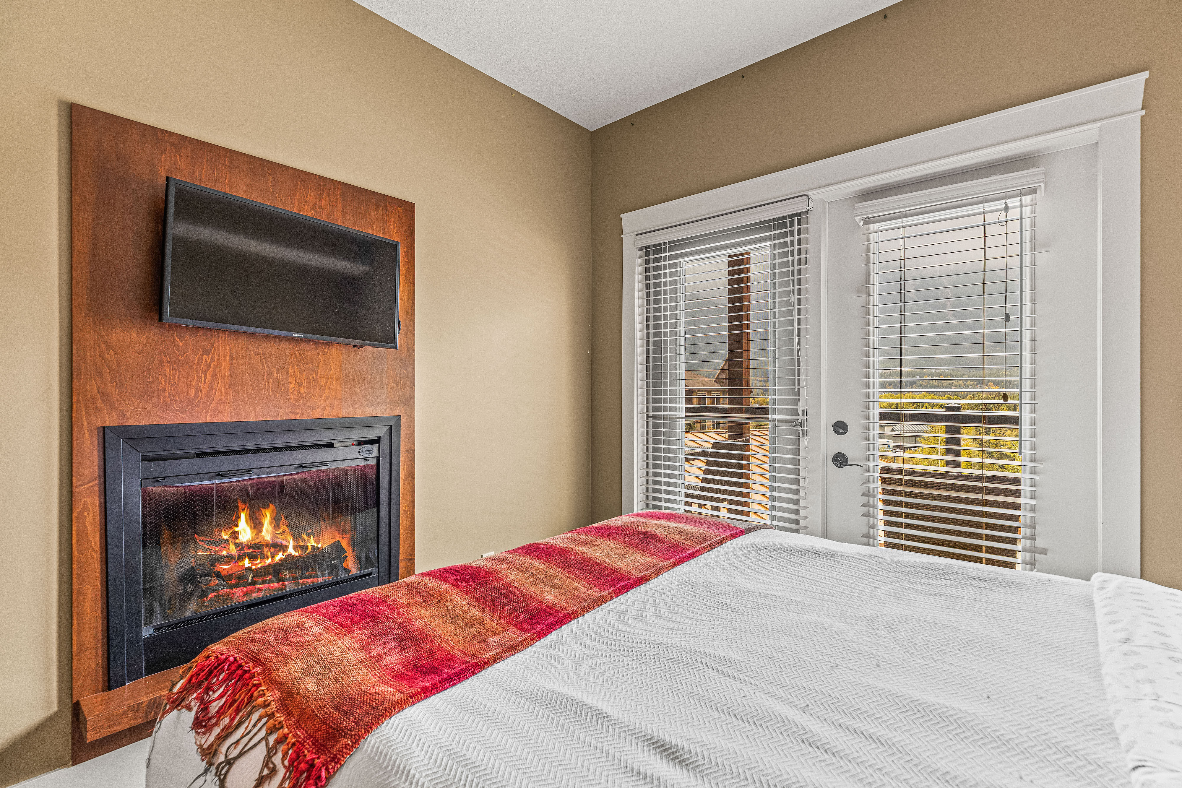 image Embrace the fireside charm in every room, enveloping you in warmth and comfort amidst the breathtaking backdrop of the Canadian Rockies.