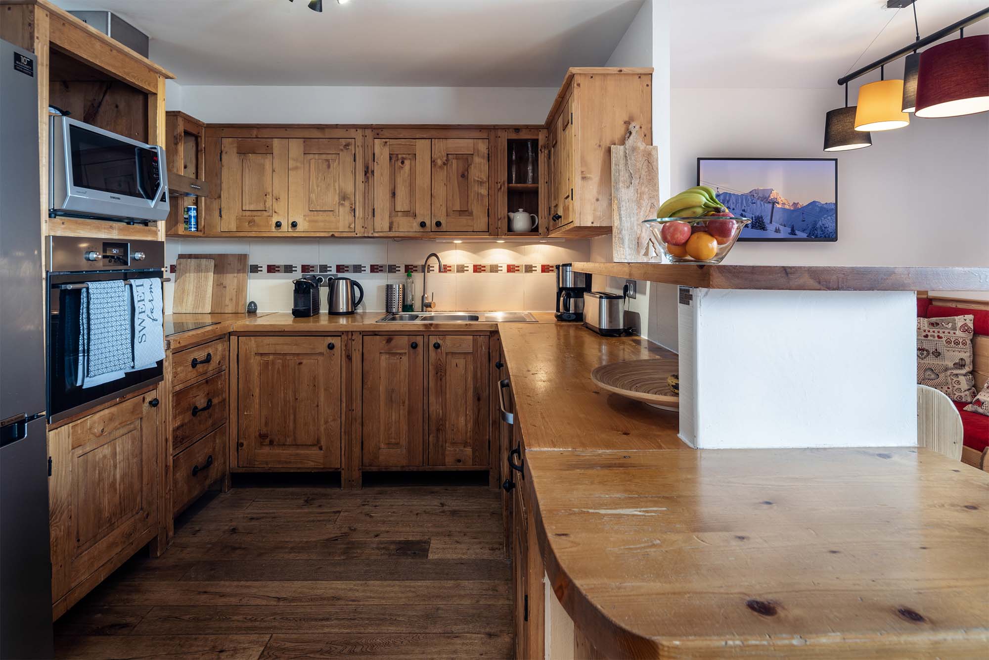 image Spacious kitchen featuring modern appliances, ample counter space, and charming rustic design
