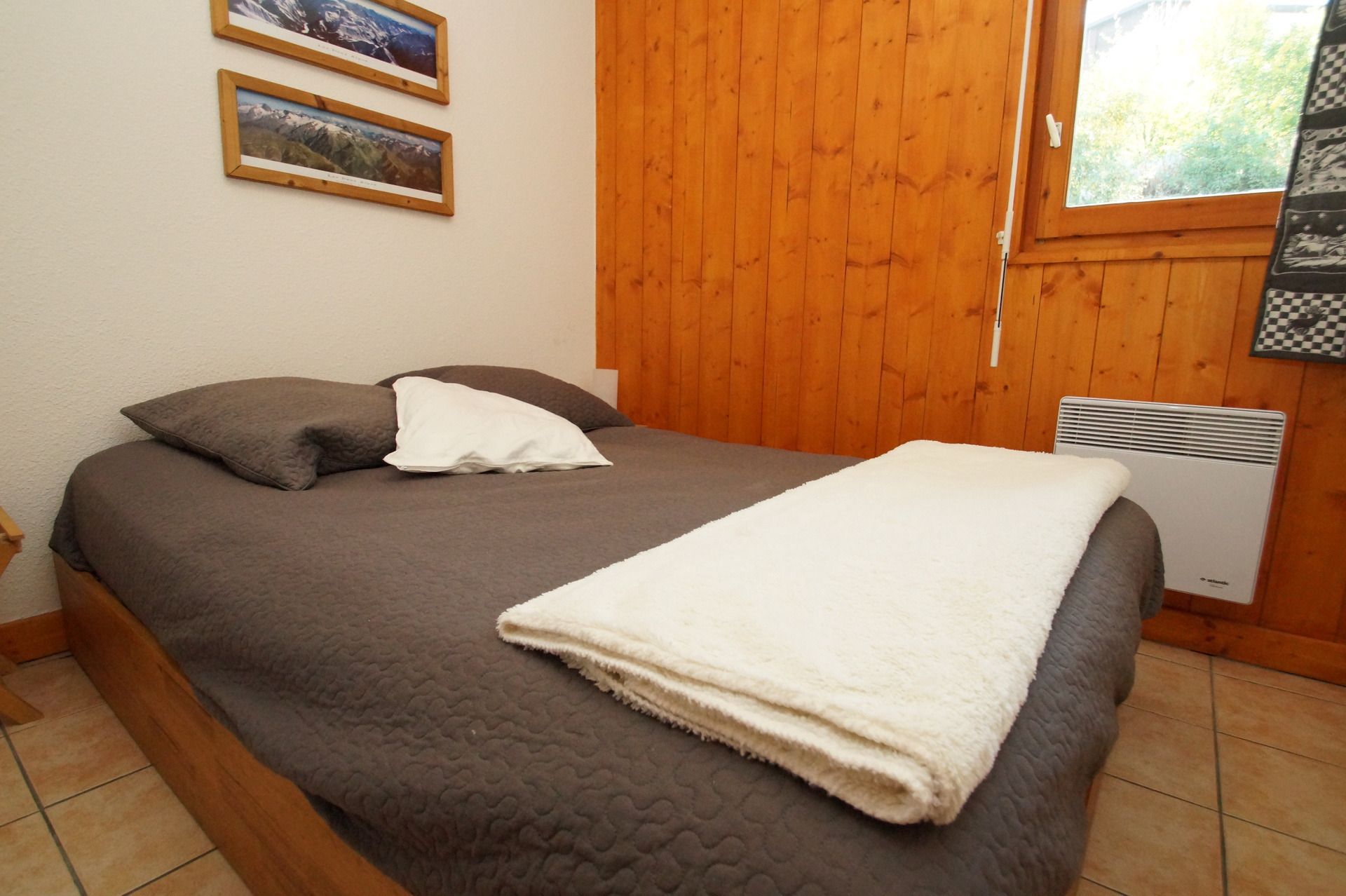 image Cosy double bed with serene mountain ambience.