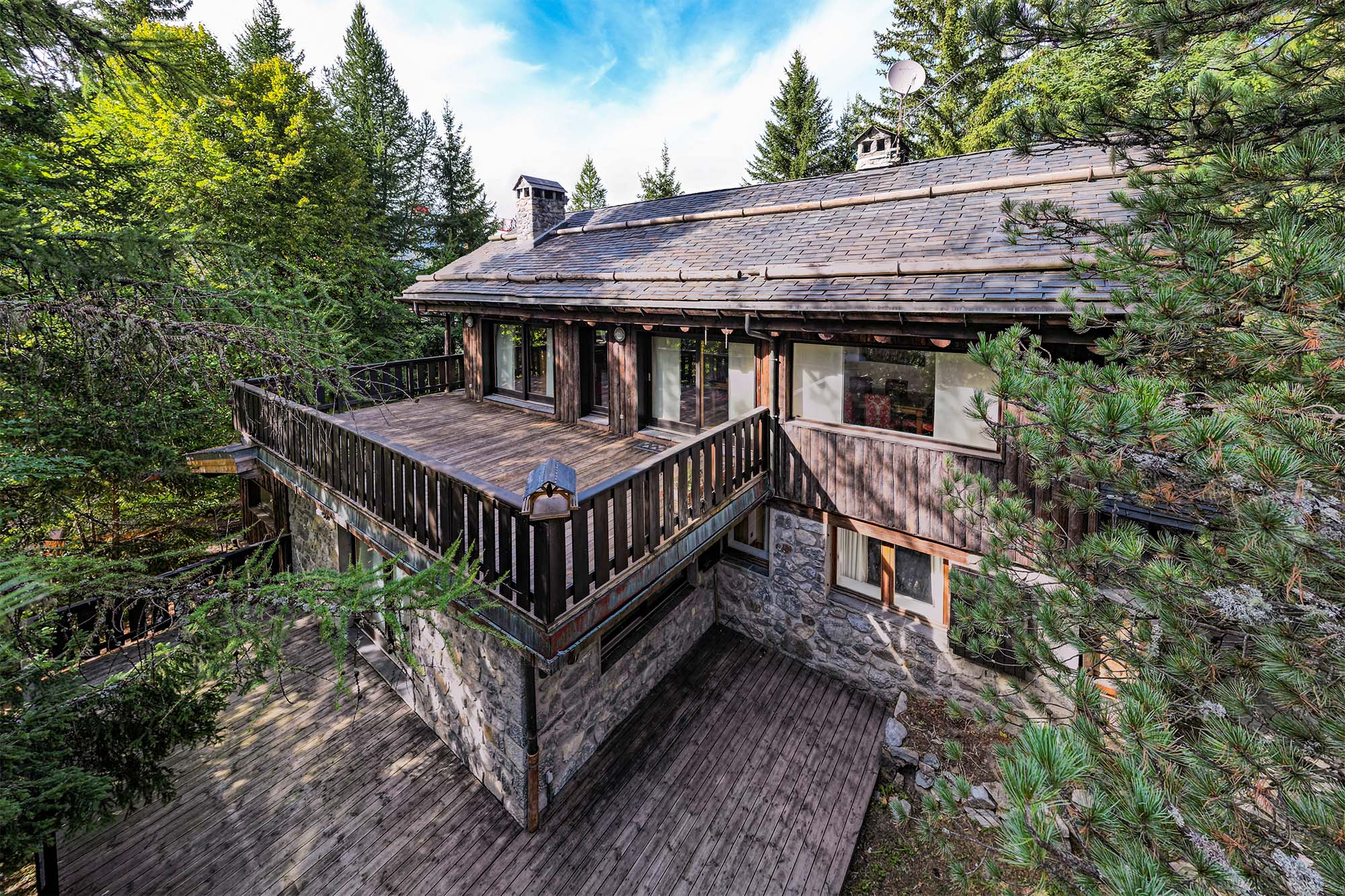 image Experience the charm of this rustic cabin nestled in the woods. The spacious deck offers a perfect spot for outdoor dining and relaxation, surrounded by serene beauty of the forest.