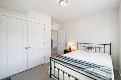 The room's simplistic design is enhanced by its pristine white doors and walls.