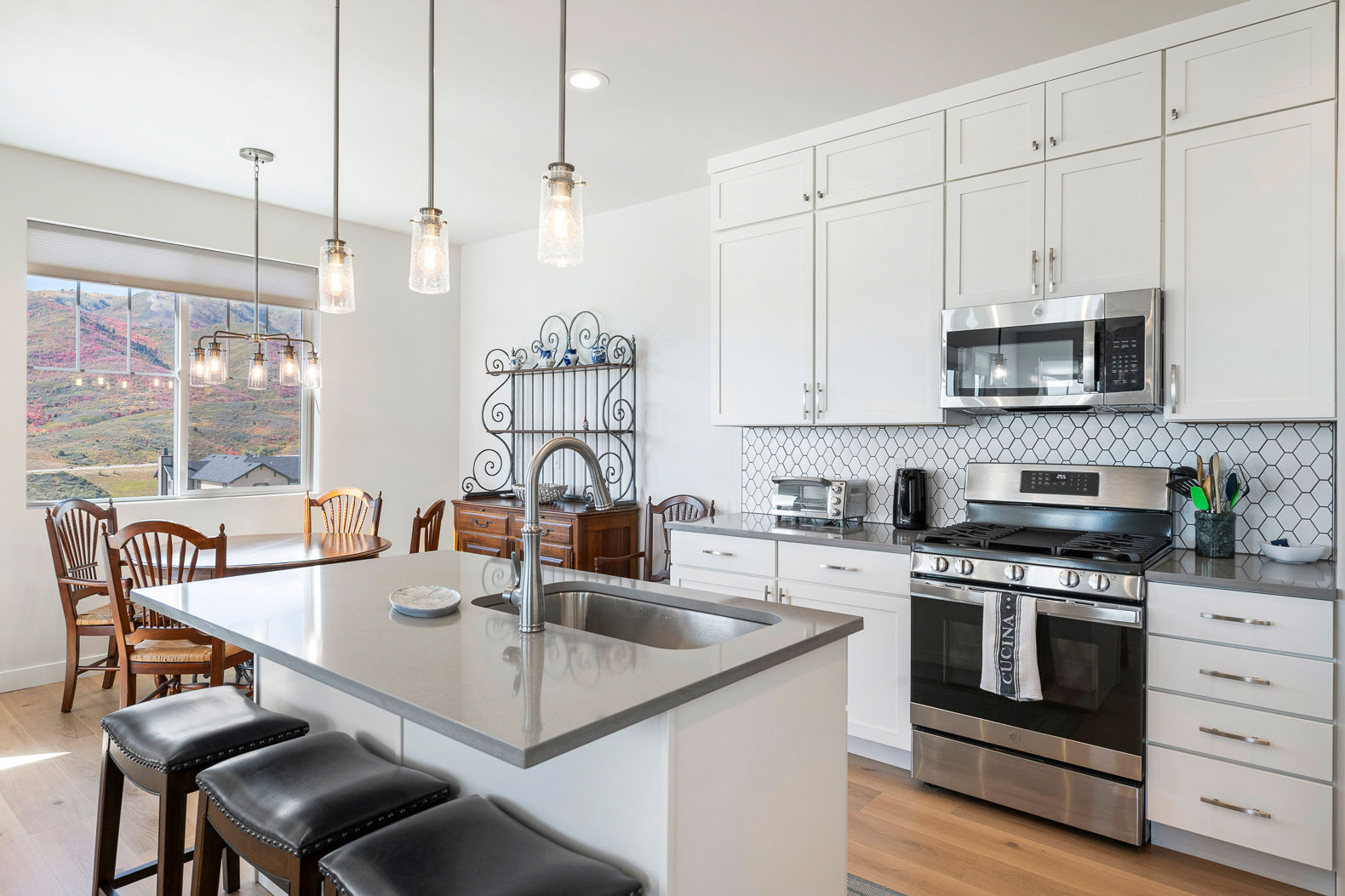 image The modern kitchen seamlessly merges with the living room area, all under the captivating backdrop of panoramic mountain vistas.