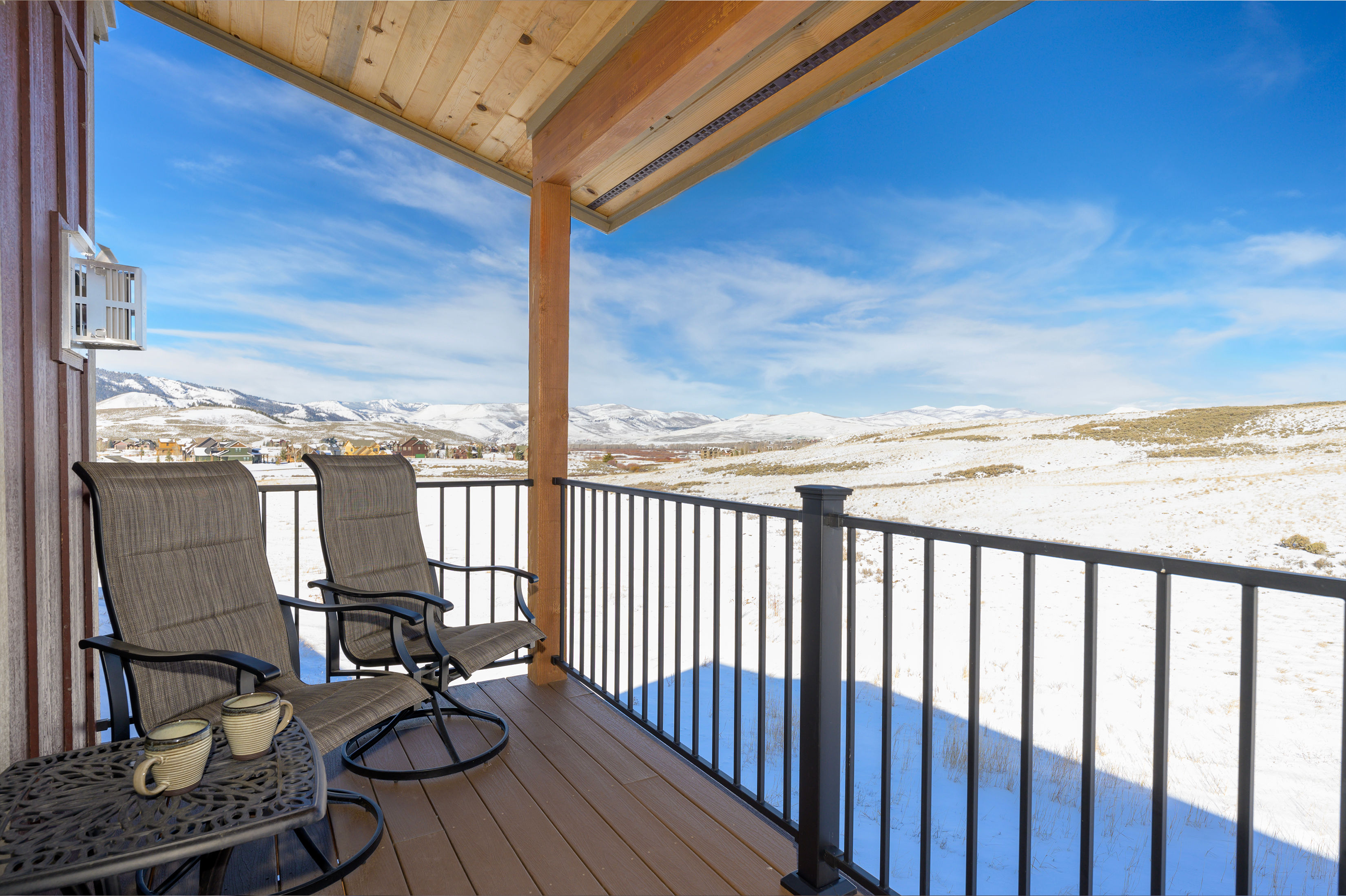 image Wake up to breathtaking snowy mountain views from this cozy deck.