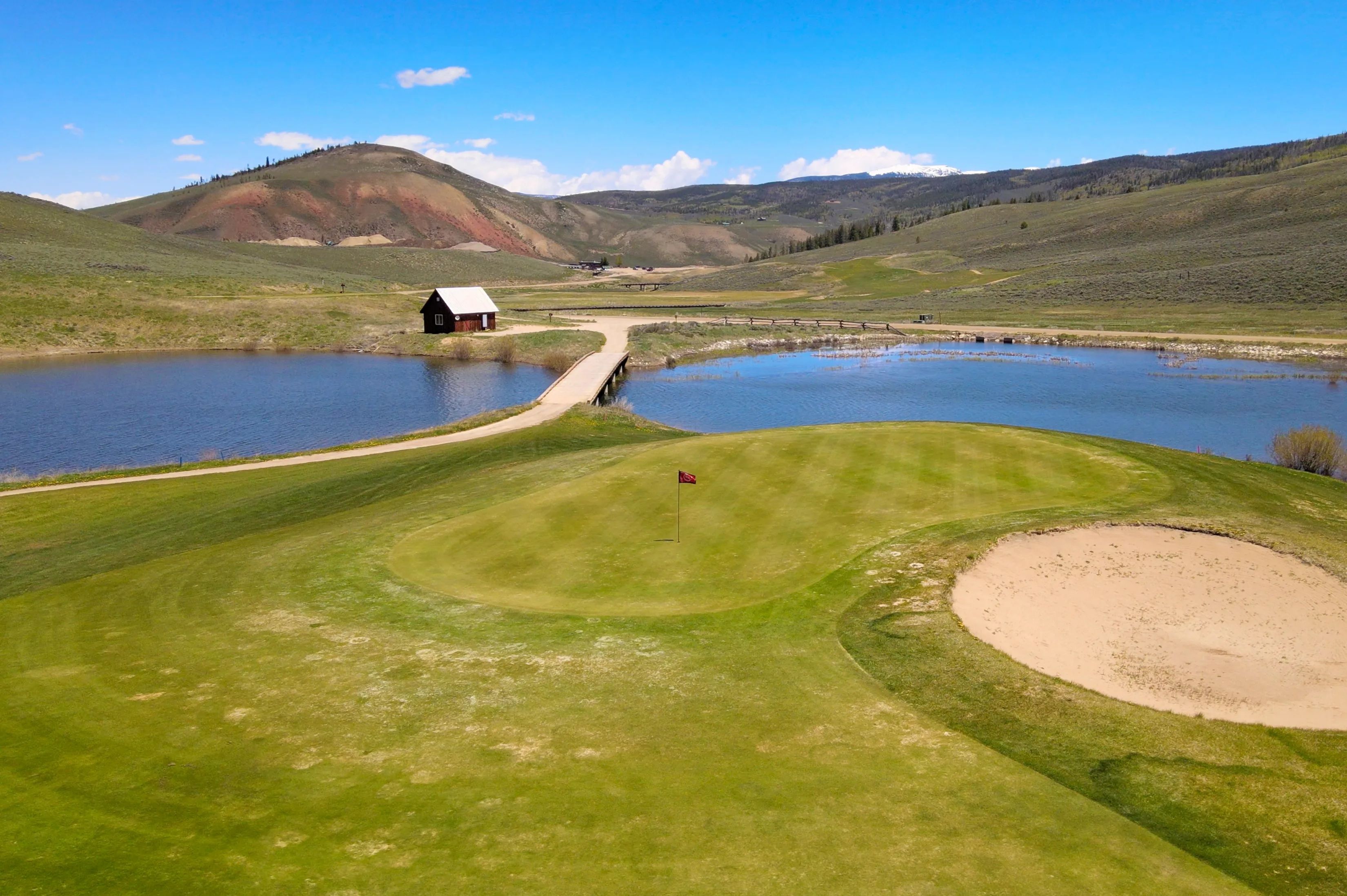 image Perfect your swing with a round of golf amidst the sweeping landscapes of Granby's lush valleys at Grand Elk Clubhouse Golf Course.