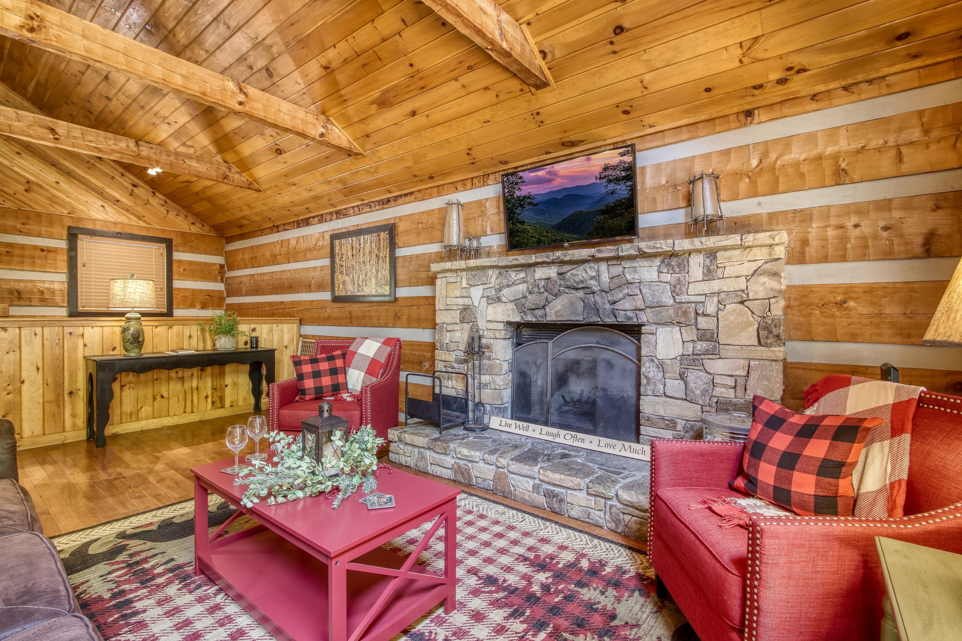 image Gather around the cozy wood-burning fireplace in a living room that combines rustic charm with plush comfort.