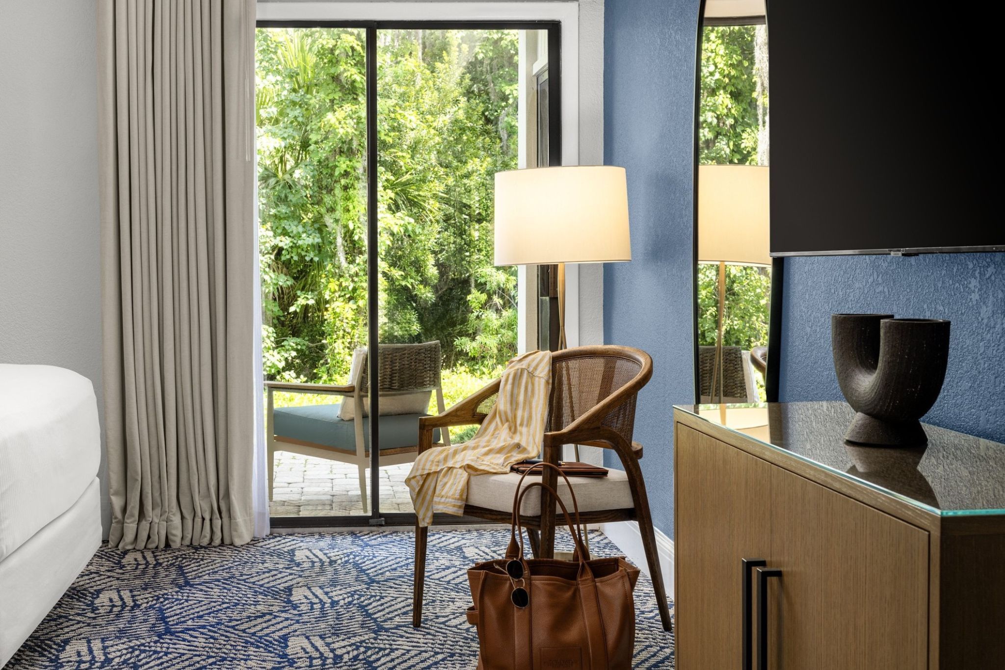 image Wake up to greenery and natural light in a serene, inviting bedroom space.