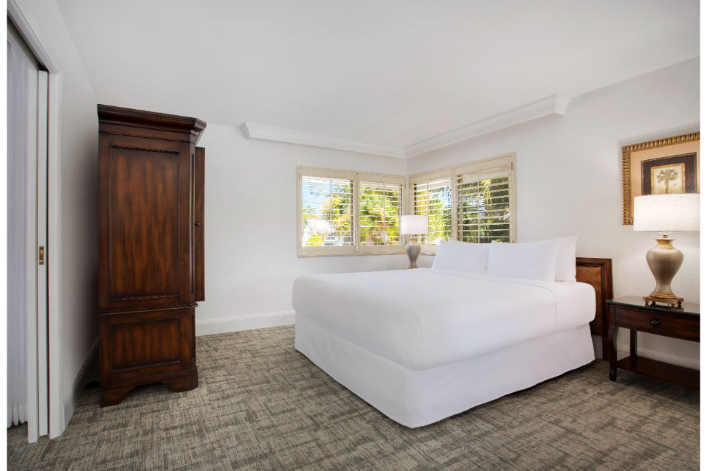 image Lavish in comfort with this expansive and pristine white bedroom.