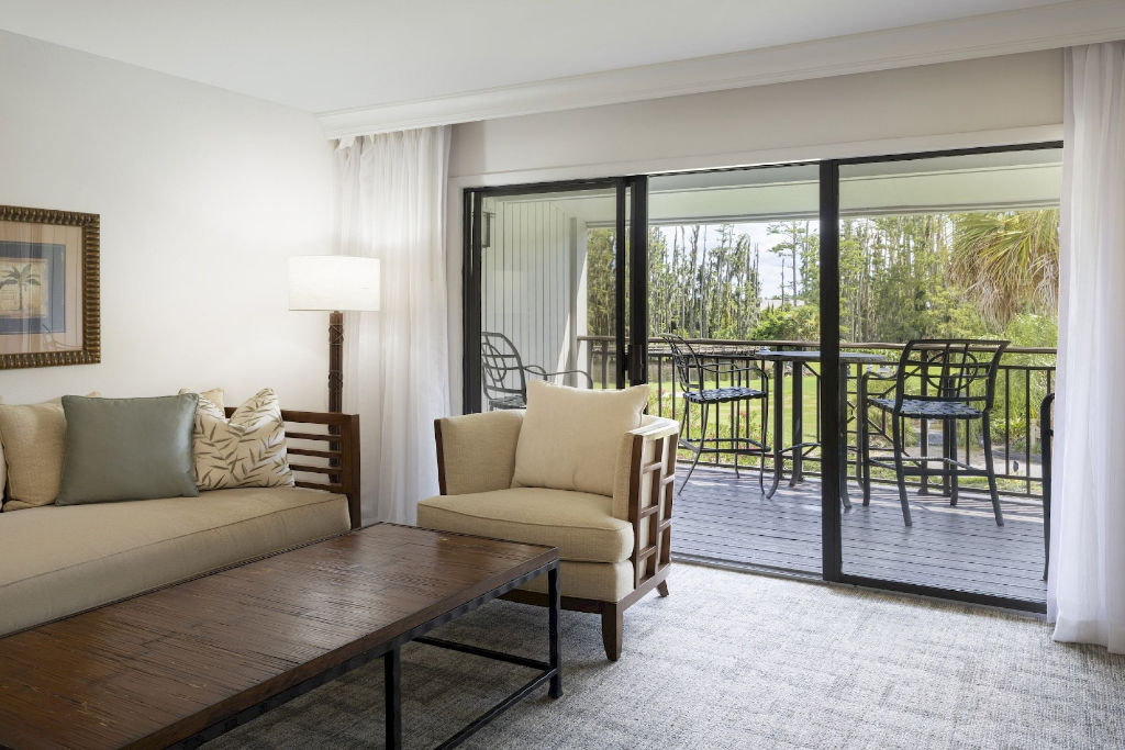 image Embrace the tranquility of this spacious living room that opens to nature's embrace on the balcony.
