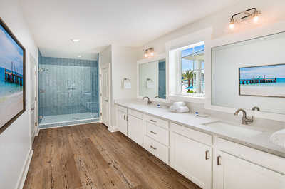 Luxurious bathroom featuring a long vanity and oceanic tile accents for a spa-like experience.