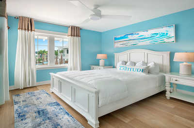 Cheerful bedroom infused with light blue hues, reflecting a tranquil beachside atmosphere.