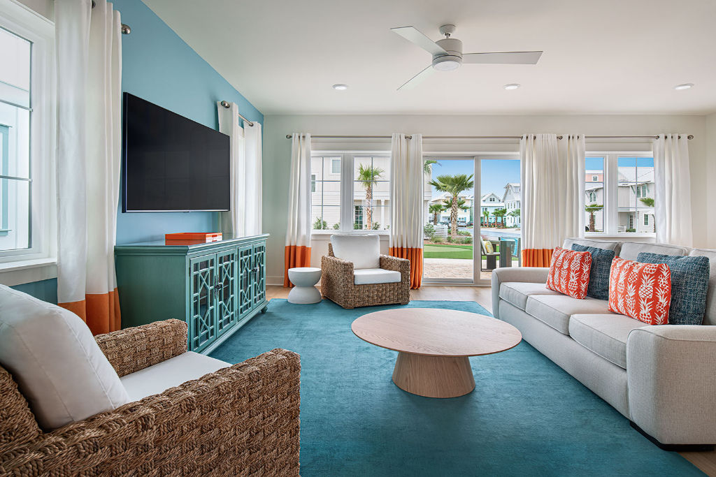 image Stylish and vibrant living room designed for comfort, with a pop of turquoise adding a seaside feel.