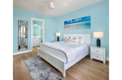 Serene bedroom retreat with calming blue accents and plush bedding for a peaceful rest.