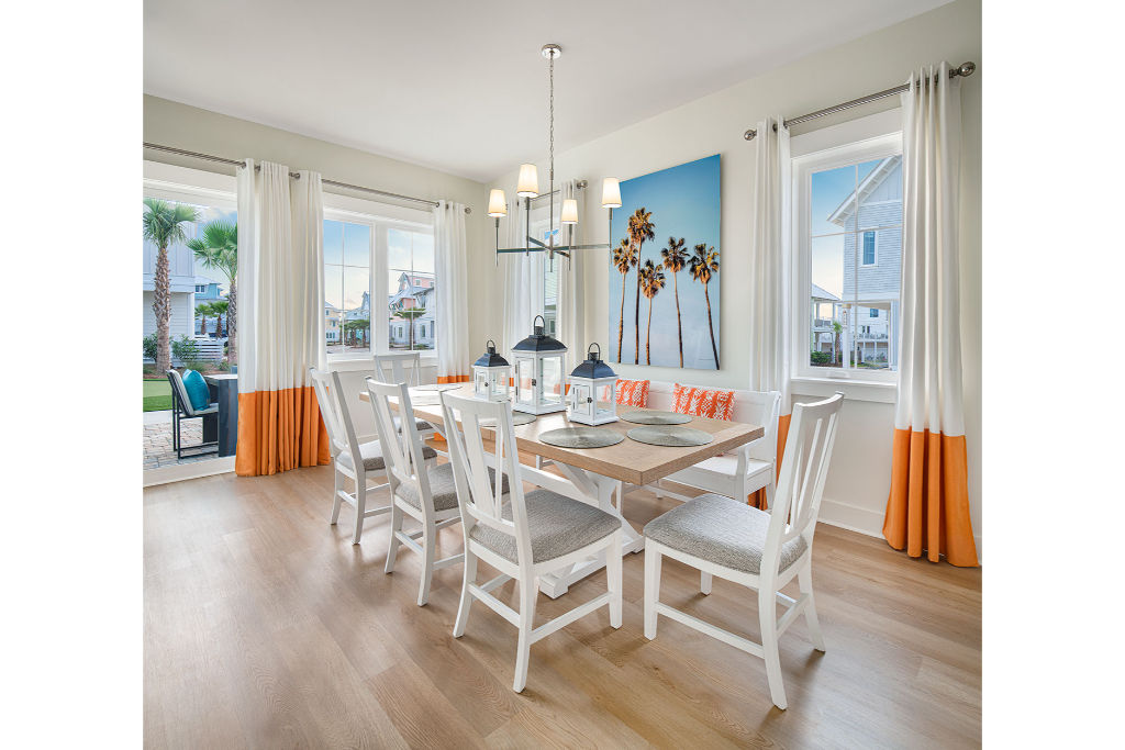 image Bright dining room accented with touches of coral, offering a refreshing space for family meals.