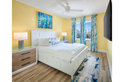 Bright and sunny bedroom with cheerful yellow walls, creating an energizing morning welcome.