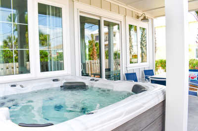 Inviting outdoor hot tub on a covered patio, perfect for relaxation in a private setting.