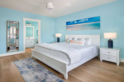 Airy bedroom with calming blue accents, offering a tranquil retreat.