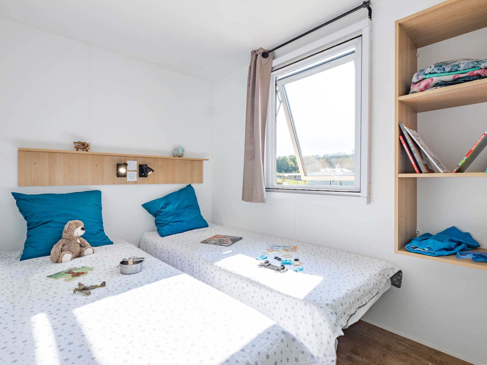 image Bright and cheerful twin bedroom with fun decorative touches, offering a delightful space for guests.