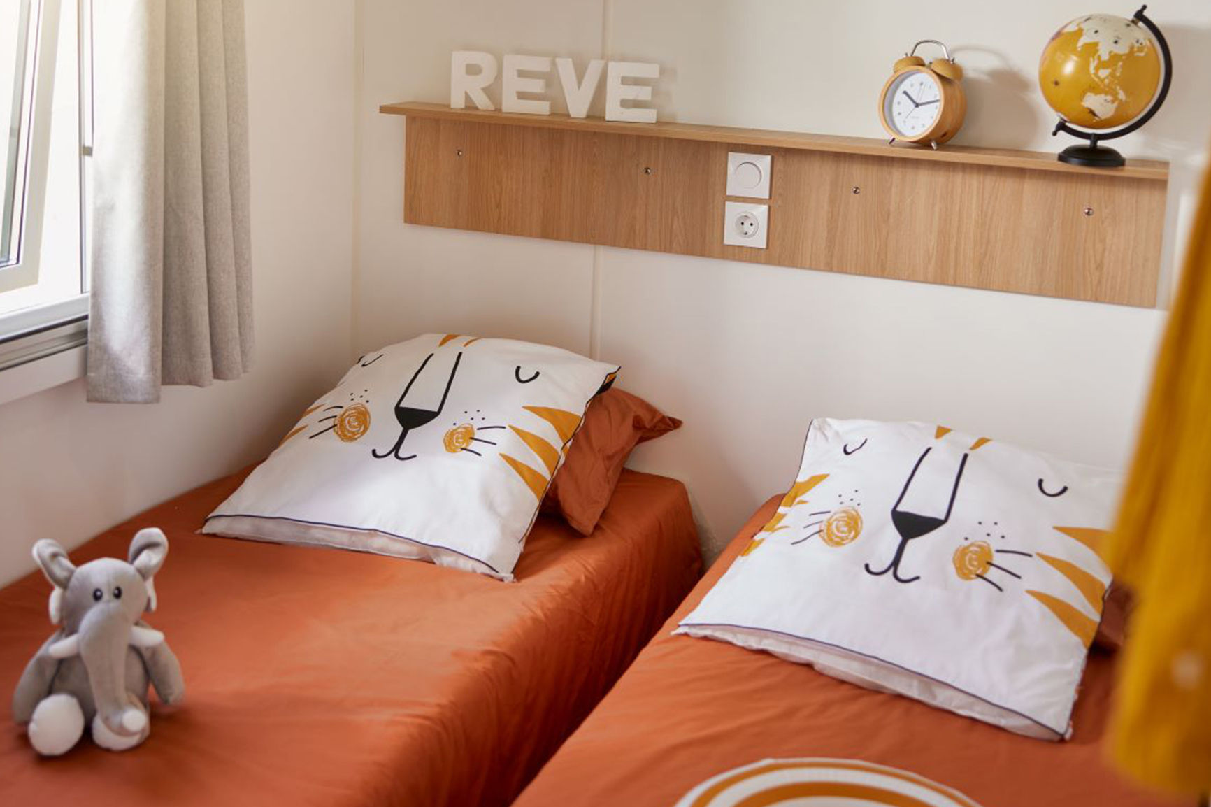 image Bright and cheerful twin bedroom with fun decorative touches, offering a delightful space for guests.