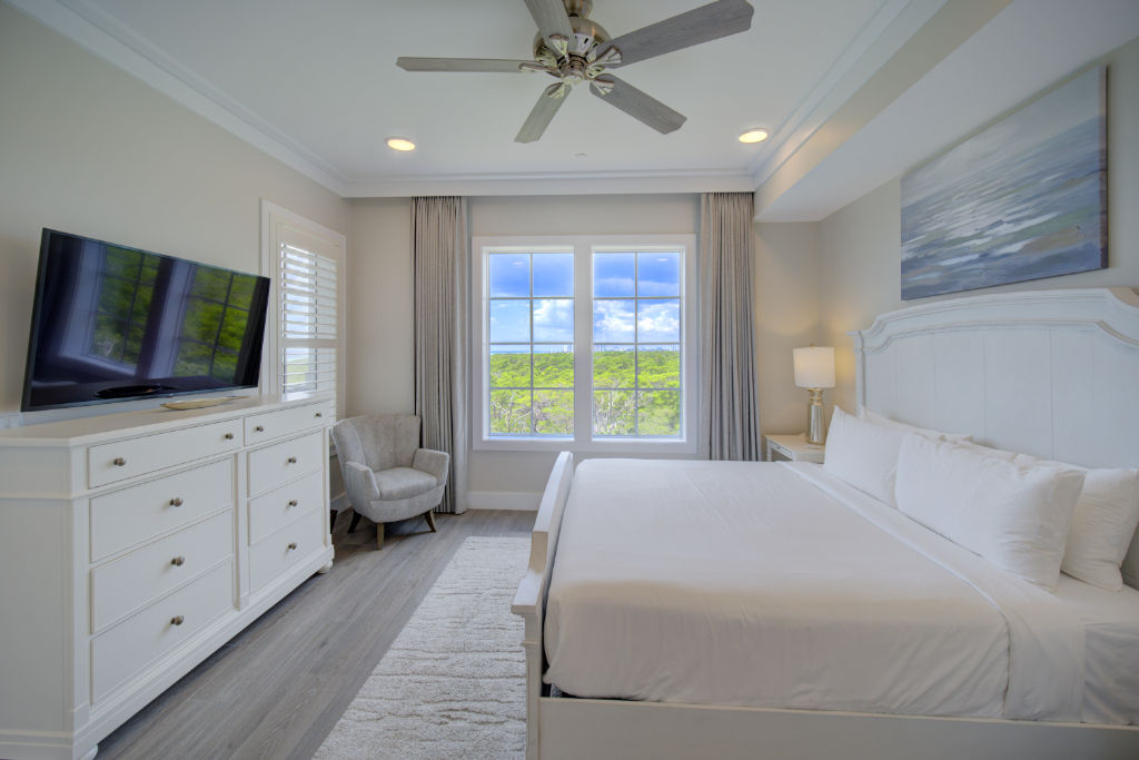 image A roomy bedroom with multiple beds, ideal for families or groups.