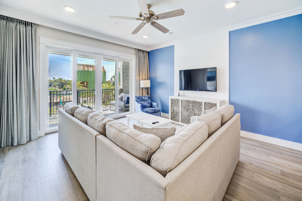 image A contemporary space where comfort meets chic, accented by cool ocean tones.