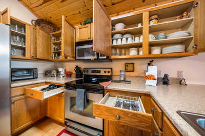 Our kitchen combines rustic aesthetics with modern functionality, featuring ample countertops and open shelving for a truly homey feel.