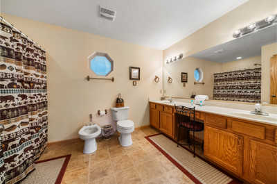 Freshen up in the ensuite master bathroom, complete with a shower/bath combo and a double sink, providing both privacy and comfort.