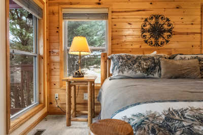 Wake up to serene forest views in this cozy bedroom, where comfort and nature meet.