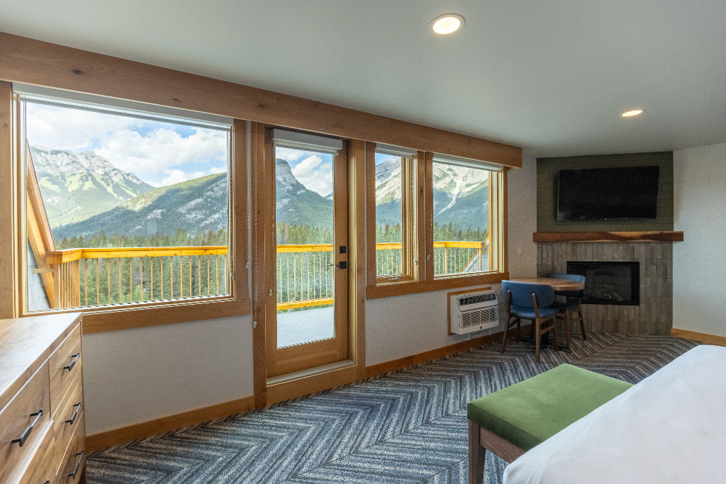 image Airy room with large windows showcasing mountain views.