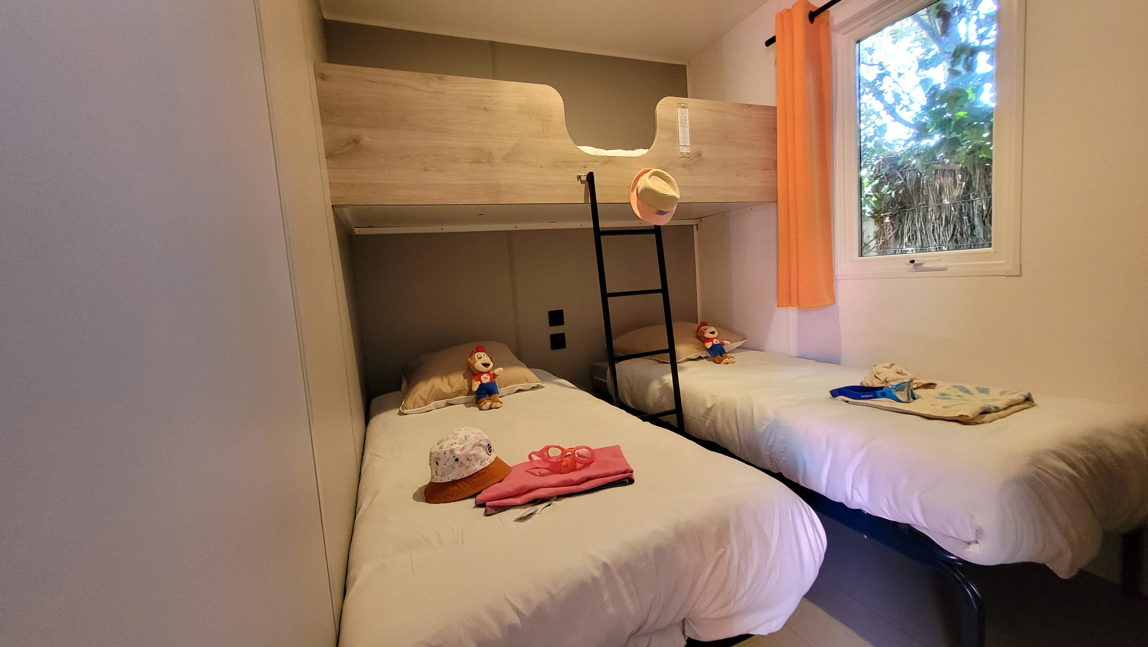 image The children's bedroom features a stylish bunk bed and cozy twin beds with playful details, ensuring a fun and comfortable sleeping space.