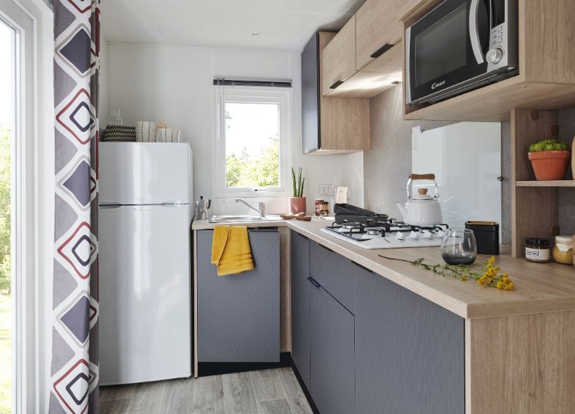 image Modern kitchenette with ample storage and a cozy dining area, perfect for home-cooked meals.