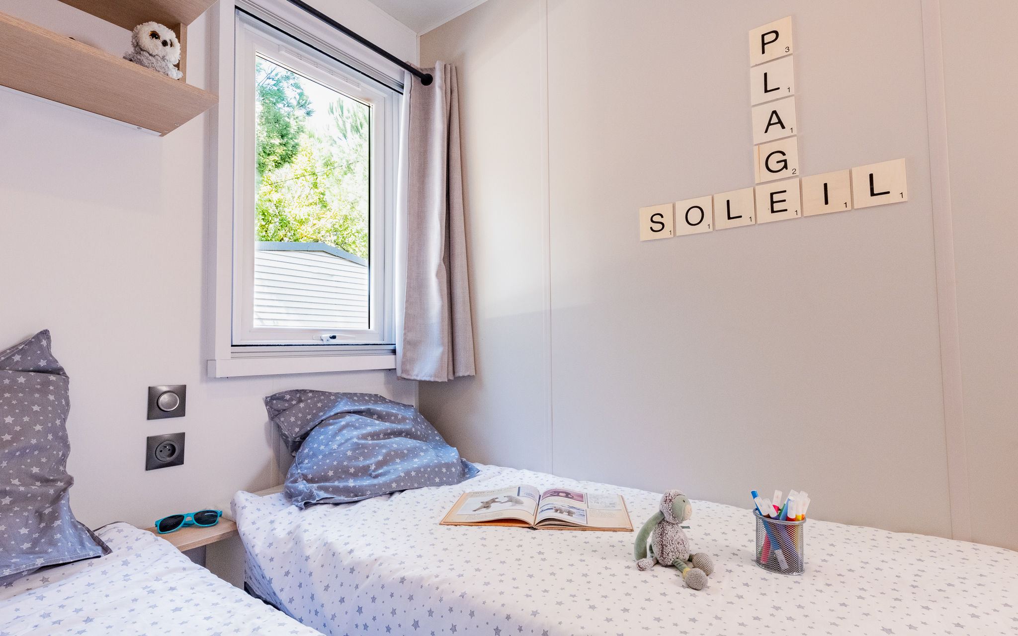 image Drift into relaxation in this charming bedroom, where soft decor and natural light create the perfect setting for unwinding.