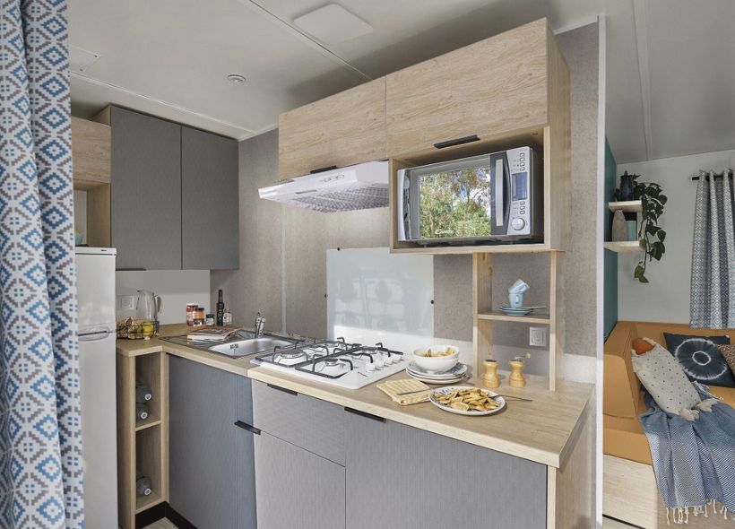 image Compact yet fully equipped kitchenette, ideal for preparing meals in a cozy setting.