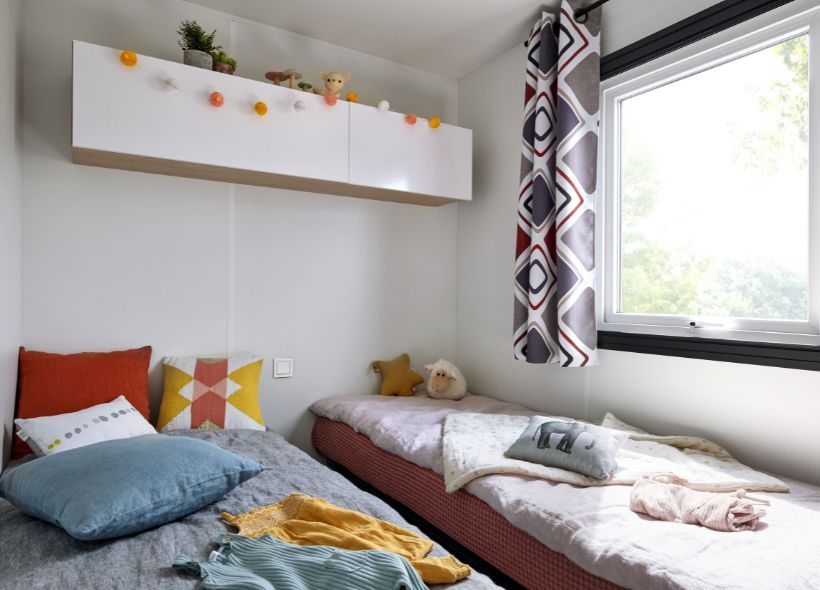 image Cheerful twin bedroom with bright accents, ideal for a comfortable night’s rest.