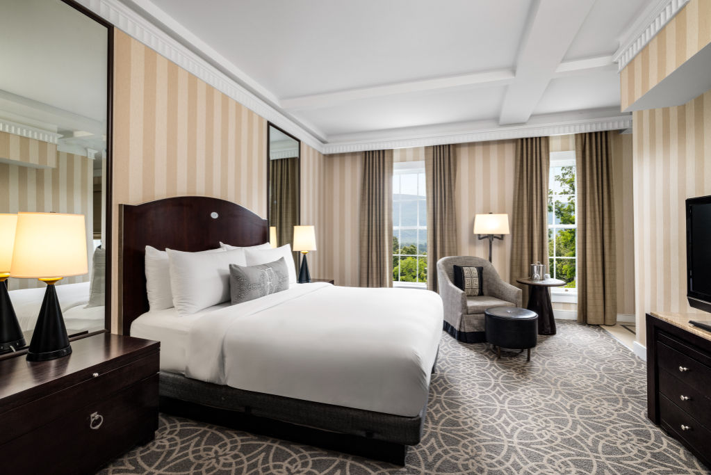 image Immerse yourself in the calming ambiance of our spacious bedroom, where luxury meets tranquility.