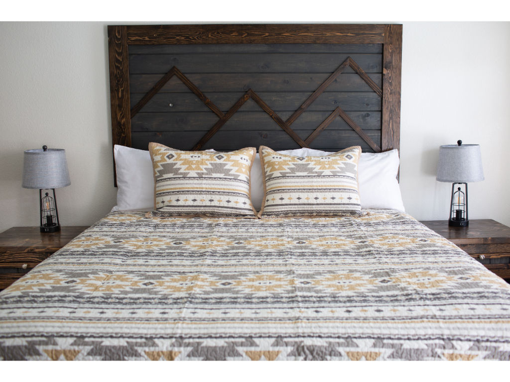 image Bedroom with earthy tones and patterned linens.