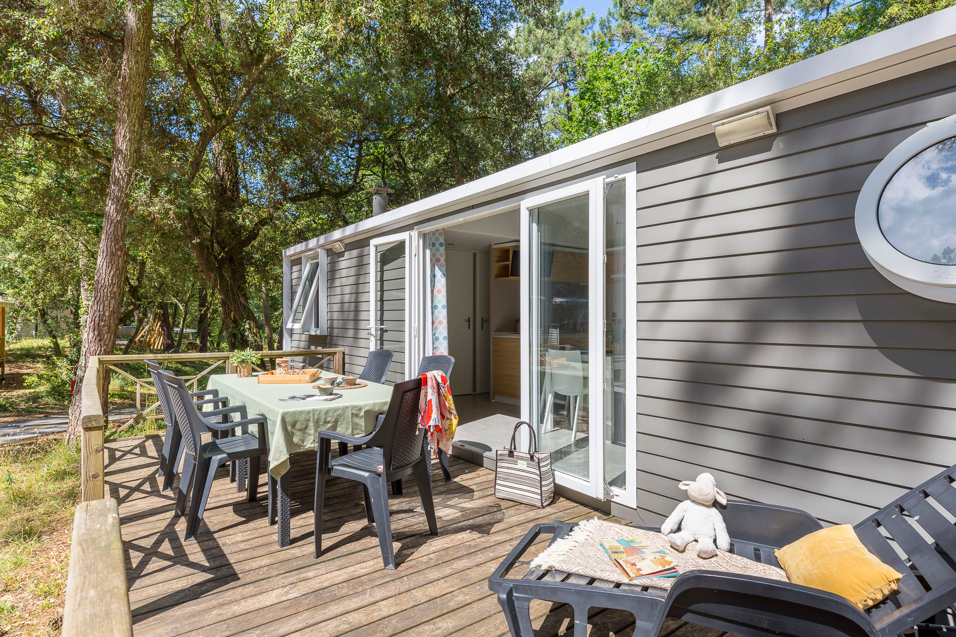 image Enjoy al fresco dining on a private deck, surrounded by lush greenery for a peaceful outdoor experience.