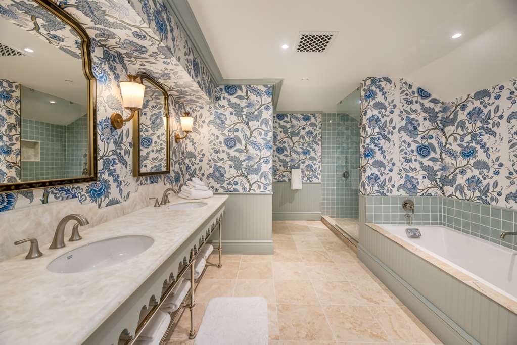 image Unwind in a spacious bath where classic patterns and soothing colors invite lingering, unhurried moments.