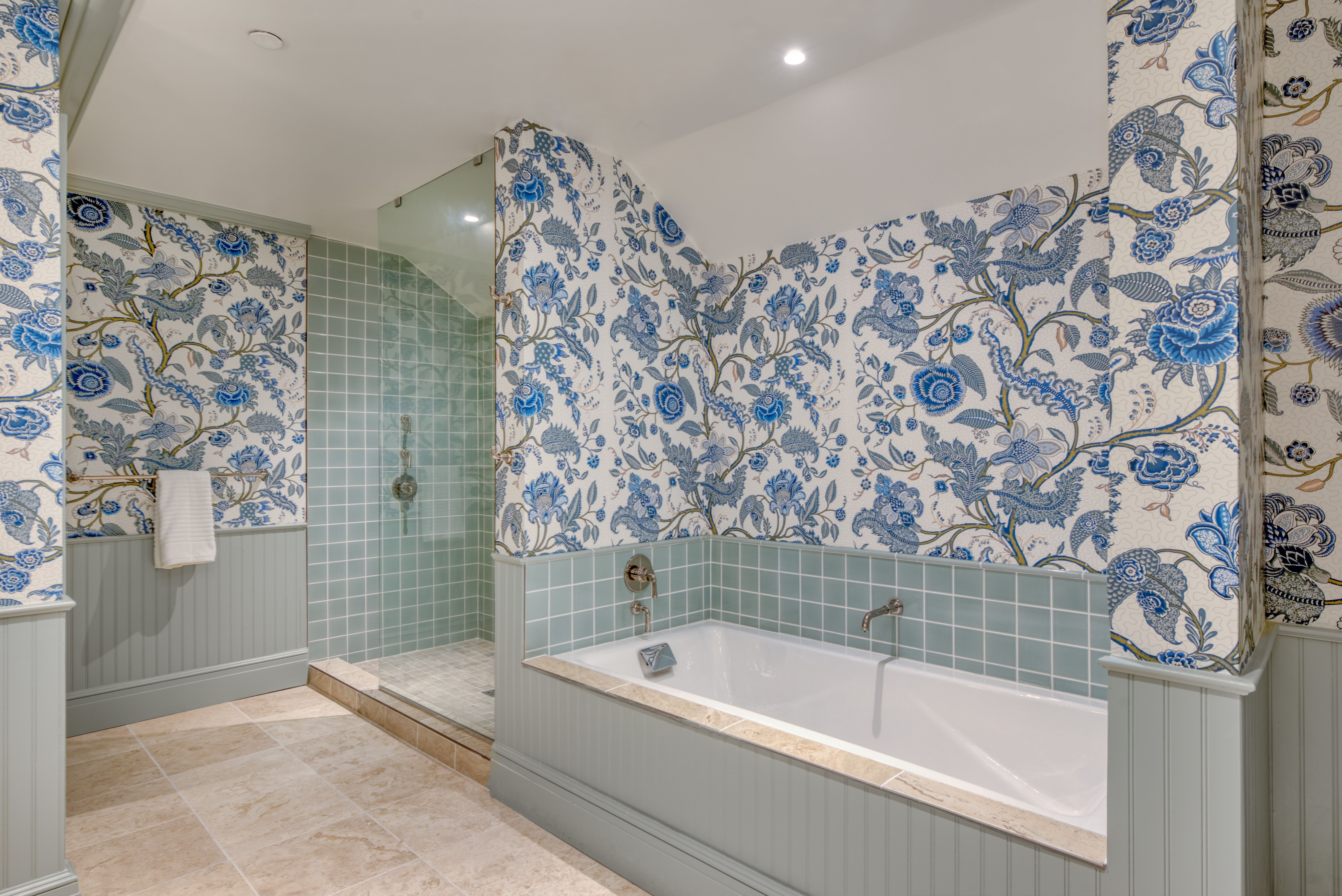 image Soothing tones and floral walls set the scene for a long soak or a refreshing rinse in this spa-like sanctuary.